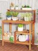 Outdoor wooden potting bench gardening workstation with open shelves for planting, tools, and patio garden storage.